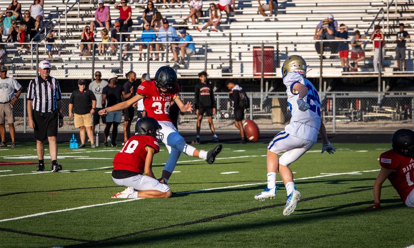 A football player kicks the ball